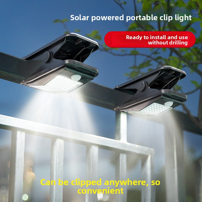 Solar powered motion sensor clip light for outdoor walls